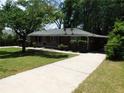 Exterior view of a brick home with a carport and well-maintained lawn at 5952 Medlock Ave, Austell, GA 30106