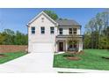 Charming two-story home with a white brick facade, attached garage, and well-manicured lawn at 140 Kingsley Way, Acworth, GA 30102