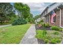 Well-maintained lawn and garden beds complement this classic brick home, showcasing its curb appeal at 830 Montego Sw Way, Lilburn, GA 30047