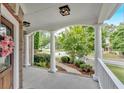 Inviting front porch with classic columns, decorative wreath, and view of landscaped yard at 212 Thorncliff Way Way, Acworth, GA 30101