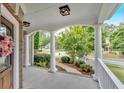 Inviting front porch with decorative columns, and views of the neighborhood at 212 Thorncliff Way Way, Acworth, GA 30101