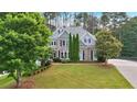 Charming two-story home with landscaped front yard, mature trees, and traditional architecture at 212 Thorncliff Way Way, Acworth, GA 30101