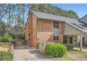 Charming brick exterior showcases a well-maintained lawn, carport, and lush landscaping at 2459 Cedar Canyon Se Ct, Marietta, GA 30067