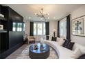 Well-lit living room featuring a sleek media center, wood floors, and contemporary decor at 371 Grant Cir # 1812, Atlanta, GA 30315