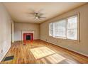 Sun-filled living room with hardwood floors, a fireplace, and large windows with blinds at 32 Hillcrest Drive Southeast Se Dr, Austell, GA 30168