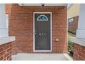 Close-up of front door with decorative glass and house number, surrounded by red brick at 801 Tulip Poplar Way # 2501, Lawrenceville, GA 30044