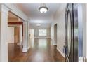 Open foyer featuring hardwood floors and detailed columns leading into a spacious living area at 805 River Valley Dr, Dacula, GA 30019