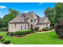 Beautiful two-story home with stone accents, lush lawn, and mature trees at 106 April Walk, Mcdonough, GA 30253