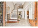 Grand foyer showcasing high ceilings, elegant staircase, and tiled floors at 106 April Walk, Mcdonough, GA 30253