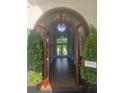 Open foyer with elegant lighting fixture, arched doorway, and views to the backyard at 1169 Hodges Cir, Mansfield, GA 30055