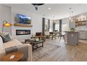 Open-concept living room featuring a fireplace, modern decor, and hardwood flooring at 241 Ivey Ter, Temple, GA 30179