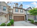Inviting townhouse with a two-car garage, manicured landscaping, and a lovely front door at 3246 Spicy Cedar Ln, Lithonia, GA 30038