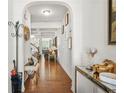 Elegant hallway with hardwood floors, white walls, and an arched entryway, showcasing a bright and open space at 3246 Spicy Cedar Ln, Lithonia, GA 30038