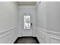 Bright entryway with white trim, gray walls, and a door with glass panels allowing natural light to illuminate the space at 5965 Vista Brook Dr, Suwanee, GA 30024