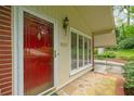 A stylish red door, stone entrance, and large multi-pane window add curb appeal to this charming home at 1103 Lee Ne Cir, Atlanta, GA 30324