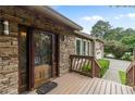 Close up of stone facade and a wood framed glass front door at 3711 Frey Lake Nw Rd, Kennesaw, GA 30144