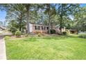 Well-maintained lawn and landscaping enhance this brick home at 60 Ivy Dr, Covington, GA 30016