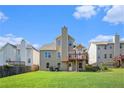 Spacious backyard with a well-manicured lawn and a raised deck perfect for outdoor entertaining at 915 Pebble Creek Trl, Suwanee, GA 30024