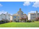 View of the backyard with a spacious lawn and a wooden deck overlooking the yard at 915 Pebble Creek Trl, Suwanee, GA 30024