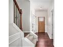 Welcoming entryway with hardwood floors, a staircase with iron railings, and a view of the front door at 915 Pebble Creek Trl, Suwanee, GA 30024