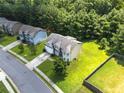 An aerial side view shows the manicured lawn of this home at 1492 Station Ridge Ct, Lawrenceville, GA 30045