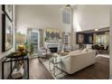 Elegant living room with tall ceilings, fireplace, large windows, and open layout to dining area at 2102 Berryhill Se Cir, Smyrna, GA 30082