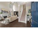 Bright and spacious living room featuring hardwood floors, fireplace, and staircase at 2102 Berryhill Se Cir, Smyrna, GA 30082