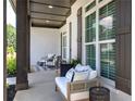 Comfortable front porch seating with stylish decor and exterior window details at 841 Keystone Dr, Woodstock, GA 30188