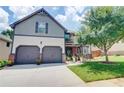 Charming two-story home with a well-manicured lawn, mature landscaping, and a two-car garage at 312 Sierra Ct, Mcdonough, GA 30253