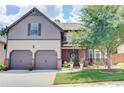 Charming two-story home with a well-manicured lawn, mature landscaping, and a two-car garage at 312 Sierra Ct, Mcdonough, GA 30253