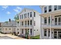 Lovely white home with double balconies and classic architectural features, surrounded by greenery at 60 Linton St, Woodstock, GA 30188