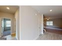 Bright hallway with hardwood floors leading to a living area with stairs and a bedroom at 3402 Milan Ct # 1 Plapprox Sqft 2, Douglasville, GA 30135