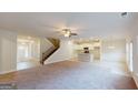 Open-concept living room featuring hardwood floors, a staircase, and a view of the modern kitchen at 3402 Milan Ct # 1 Plapprox Sqft 2, Douglasville, GA 30135