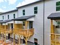 Townhome back porches with wood railings and gray siding offer a place to relax outdoors at 6 Rock Park Way # 15, Tucker, GA 30084