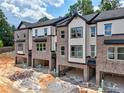 Modern townhome with brick facade, attached garages, and neutral-toned siding at 6 Rock Park Way # 15, Tucker, GA 30084