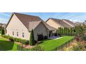 Private backyard with a covered patio and well-maintained landscaping and fence at 5640 Hammock Way, Cumming, GA 30028