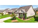 Well-maintained home exterior with lush green lawn and manicured landscaping at 5640 Hammock Way, Cumming, GA 30028