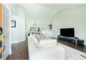 Bright and airy living room with an open floor plan flowing into the kitchen and dining area at 787 Mckendree Lake Way, Lawrenceville, GA 30043