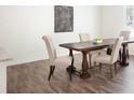 Elegant dining room with wood floors, a large table, and upholstered chairs at 2308 Argento Cir, Dacula, GA 30019