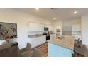 Modern kitchen featuring white cabinets, granite countertops, stainless steel appliances, and island seating at 2308 Argento Cir, Dacula, GA 30019