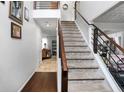 View of the carpeted staircase with modern railing and a view into the living room at 306 Overbend Sw Lndg, Marietta, GA 30008