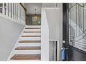 Welcoming foyer with hardwood stairs, decorative molding, and a stylish front door with glass at 397 Lovejoy Cir, Powder Springs, GA 30127