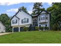 Inviting home with a well-maintained lawn, two-car garage and a classic architectural style at 397 Lovejoy Cir, Powder Springs, GA 30127