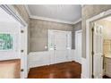 Elegant foyer with hardwood floors, white trim, and access to multiple rooms, including a bathroom at 5427 Trentham Dr, Atlanta, GA 30338