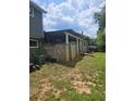 Backyard view features a covered patio and a cinder block foundation at 616 Burnt Creek Nw Way, Lilburn, GA 30047