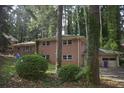 This house has a two-story brick exterior, surrounded by trees and greenery at 3798 King Henry Sw Rd, Atlanta, GA 30331