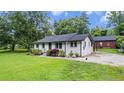Lovely exterior with grassy lawn, tidy landscaping, and convenient rear parking pad at 5599 Redan Cir, Stone Mountain, GA 30088