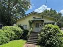 Charming one-story home with inviting entrance and lush landscaping with mature shade trees at 661 Federal Se Ter, Atlanta, GA 30315