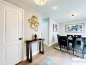 Inviting dining room featuring modern decor, stylish lighting, and seamless flow to the living space at 430 Thornbush Trce, Lawrenceville, GA 30046