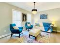 Bright living room featuring contemporary furnishings, stylish light fixture, and colorful accents at 430 Thornbush Trce, Lawrenceville, GA 30046